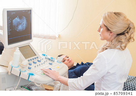 beautiful gynecologist examines the medical devices. The patient lies on the couch 85709341