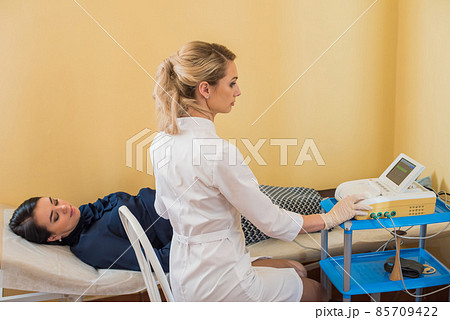 beautiful gynecologist examines the medical devices. The patient lies on the couch 85709422