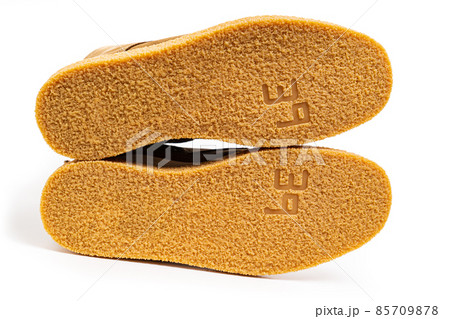 non-slip outsoles of two brown leather winter boots on a white background non-slip outsoles of two brown leather winter boots on a white background 85709878