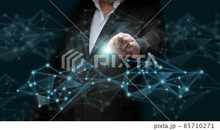 A businessman in a suit stands against the background of a hologram and holds a bunch of keys in his hand. Sale and rental of cars, purchase of real estate, mortgage A businessman in a suit stands against the background of a hologram and holds a bunch of keys in his hand. Sale and rental of cars, purchase of real estate, mortgage 85710271