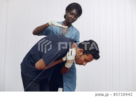 African woman provides medical care to men. 85710442