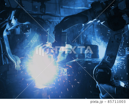welding robot in the automotive parts industry, The movement of the robot welding in auto parts factory. welding robot in the automotive parts industry, The movement of the robot welding in auto parts factory. 85711003