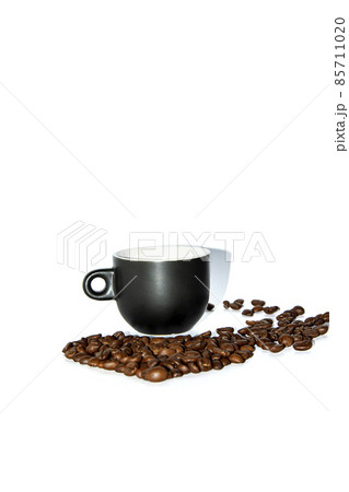 Black heart shaped coffee cup with scattered beans on a white background. Front view. Isolate. Lifestyle. Black heart shaped coffee cup with scattered beans on a white background. Front view. Isolate. Lifestyle. 85711020