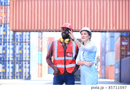 team engineer he is working in container box yard area of logistics transportation import export or shipping industry team engineer he is working in container box yard area of logistics transportation import export or shipping industry 85711097