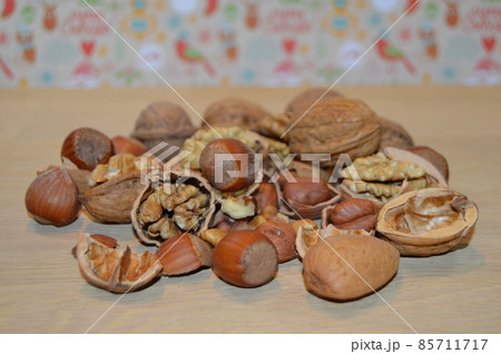 Almonds, hazelnuts, walnuts and other. Healthy food snack mix on white table, top view, copy space Almonds, hazelnuts, walnuts and other. Healthy food snack mix on white table, top view, copy space 85711717