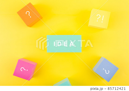 Creativity and idea concept. Single word idea written on blue rectangle surrounded by multicolored cubes with question signs Creativity and idea concept. Single word idea written on blue rectangle surrounded by multicolored cubes with question signs 85712421