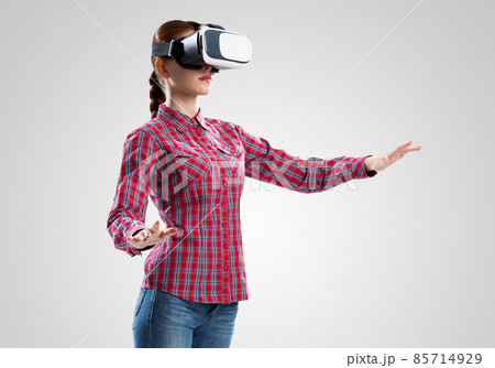 Girl in mask experiencing virtual reality as new entertainment device 85714929