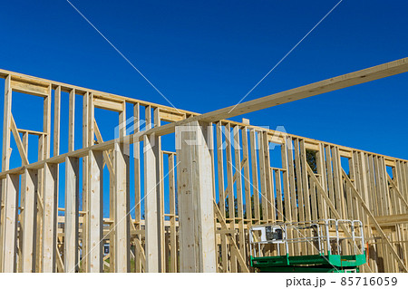 Fragment of a new home under construction wood framing beams Fragment of a new home under construction wood framing beams 85716059