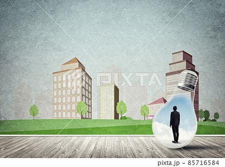 Businessman trapped in bulb Businessman trapped in bulb 85716584