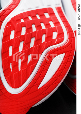 Close-up of the sole of a sport running shoe for running in red Close-up of the sole of a sport running shoe for running in red 85718698