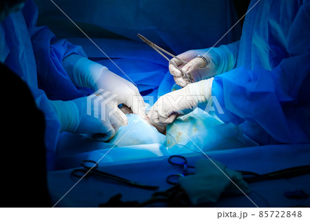 Surgical instruments in the hands of doctors during a surgical operation. Surgical instruments in the hands of doctors during a surgical operation. 85722848