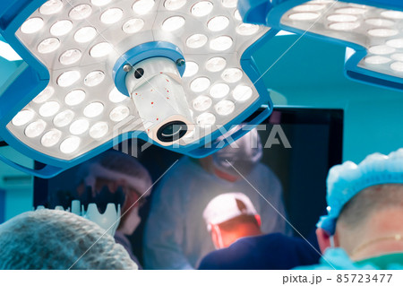 Medical lighting above the operating table during surgery. 85723477