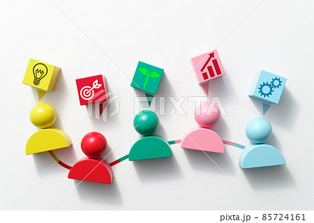 チームワークと創造性。様々な色の人の形をしたブロックとアイコンが描かれた立方体の俯瞰。 チームワークと創造性。様々な色の人の形をしたブロックとアイコンが描かれた立方体の俯瞰。 85724161