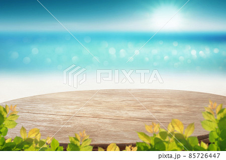Wooden table top with blurry sea veiw blue sky and blured green leave as frame Product Dispaly stand background concept Wooden table top with blurry sea veiw blue sky and blured green leave as frame Product Dispaly stand background concept 85726447