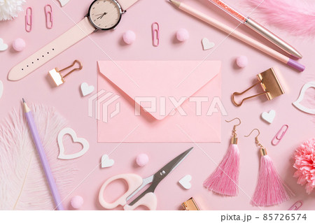 Pink envelope, school girly accessories and hearts on pastel pink top view, mockup 85726574