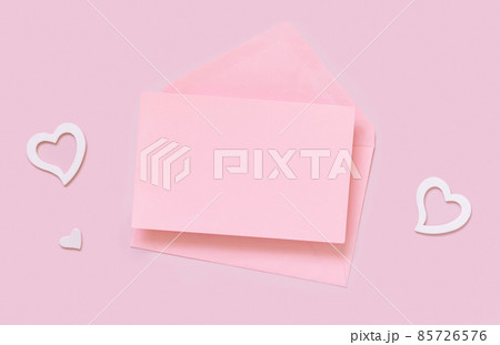 Pink paper card and envelope and hearts on pink top view, card mockup 85726576