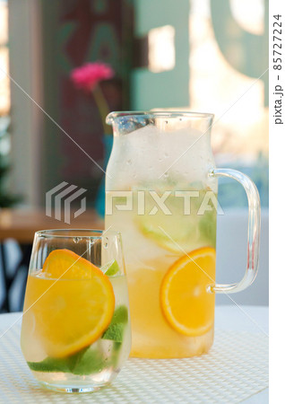 cold lemonade in a decanter and in a glass 85727224