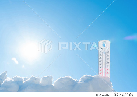 The thermometer lies on the snow in winter showing a negative temperature.Meteorological conditions in a harsh climate in winter with low air and ambient temperatures.Freeze in wintertime.Sunny winter The thermometer lies on the snow in winter showing a negative temperature.Meteorological conditions in a harsh climate in winter with low air and ambient temperatures.Freeze in wintertime.Sunny winter 85727436
