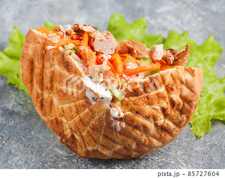 shaverma in pita or pita bread with chicken fillet and vegetables shaverma in pita or pita bread with chicken fillet and vegetables 85727604