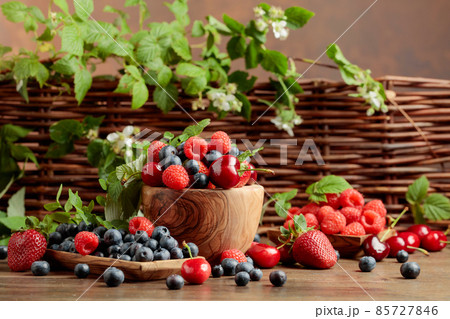 Various fresh berries on a wooden table. Various fresh berries on a wooden table. 85727846
