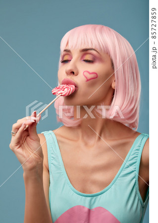 Candy Lolli pop Party Girl posing in blue studio. Role-playing games, halloween concept, sweet lover 85727859