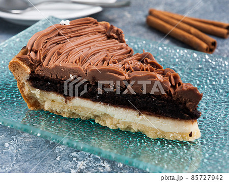 cheese and chocolate cake slice with whipped cream 85727942