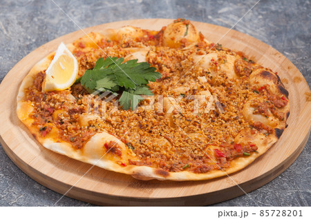 lahmacun with walnuts is a Turkish dish similar to a pizza lahmacun with walnuts is a Turkish dish similar to a pizza 85728201