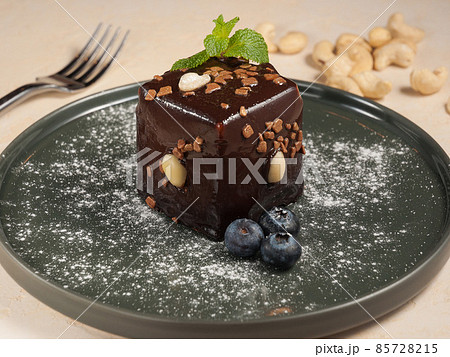 cake with chocolate and nuts in chocolate glaze 85728215