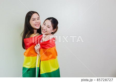 asian girl homosexual with gay flag. lesbian couple, symbolic expression LGBTQ flag. asian girl homosexual with gay flag. lesbian couple, symbolic expression LGBTQ flag. 85728727