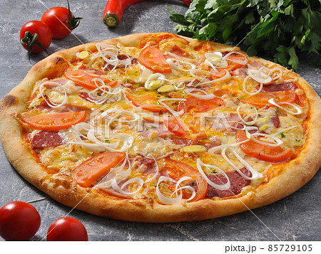 pizza with meat bacon, sausage, tomatoes and cheese 85729105