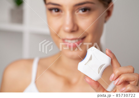 Smiling women use dental floss white healthy teeth. 85730722