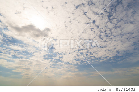 Clear blue sky with white fluffy clouds at noon. Day time. Abstract nature landscape background. Clear blue sky with white fluffy clouds at noon. Day time. Abstract nature landscape background. 85731403