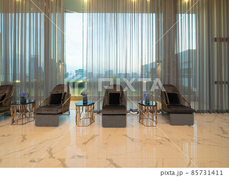 Inside of modern hotel lobby, entrance and reception, interior architecture design decoration, waiting area with urban city view of outdoor, indoor. Inside of modern hotel lobby, entrance and reception, interior architecture design decoration, waiting area with urban city view of outdoor, indoor. 85731411