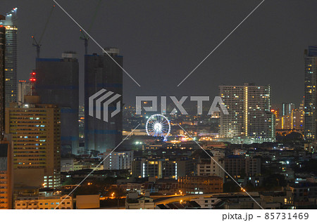 A ferris wheel in Bangkok, Thailand. Financial district and skyscraper buildings. Downtown skyline at night. A ferris wheel in Bangkok, Thailand. Financial district and skyscraper buildings. Downtown skyline at night. 85731469