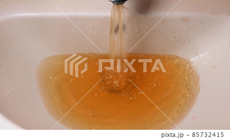 Rusty Water Pours From Tap. Water Pollution. Global Environment 85732415