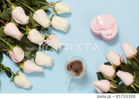 Gift box with rose flowers on the blue background. Gift box with rose flowers on the blue background. 85733300