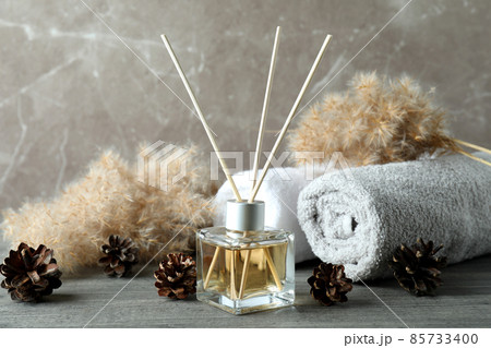 Diffuser and bath accessories on gray textured table 85733400