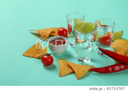 Party concept with tequila, guacamole and chips Party concept with tequila, guacamole and chips 85733767