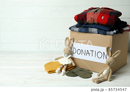 Concept of donate with donation box on white wooden table 85734547
