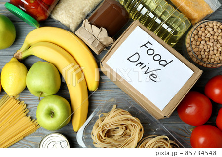 Concept of food drive with meal on wooden table Concept of food drive with meal on wooden table 85734548