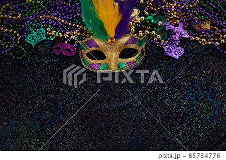 Mardi Gras Mask and colorful Mardi Gras Beads Background Mardi Gras Mask and colorful Mardi Gras Beads Background 85734776
