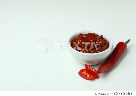 Red chili pepper and sauce on white background 85735268