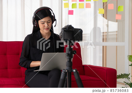 Vlog Asian woman blogger influencer sitting on the sofa in home and recording video blog for teaching and coach her Students or subscriber. Concept of the content creator online for a new lifestyle 85736083