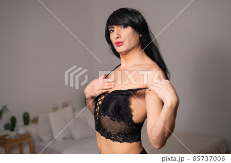 Fotografia do Stock: Gay man in wig and black lace lingerie.