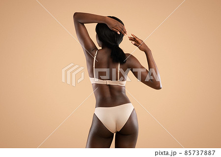 Back view of slim black woman in underwear demonstrating body Back view of slim black woman in underwear demonstrating body 85737887