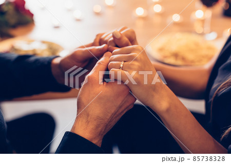 Couple having dinner, focus on hands and ring 85738328