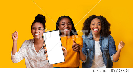 Three emotional black ladies gesturing on yellow, showing cellphone, mockup 85738336
