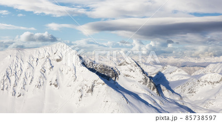 Aerial Panoramic View of Canadian Mountain covered in snow. Aerial Panoramic View of Canadian Mountain covered in snow. 85738597