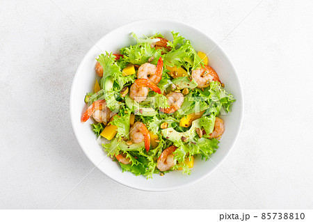 Grilled shrimp salad with avocado, mango, lettuce and pistachios, dressed with lime. Healthy food. Ketogenic diet. Top view. Grilled shrimp salad with avocado, mango, lettuce and pistachios, dressed with lime. Healthy food. Ketogenic diet. Top view. 85738810