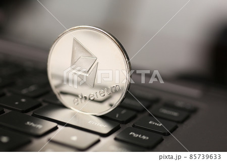 Ethereum silver coin on laptop pc keyboard 85739633